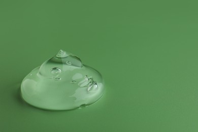 Photo of Sample of gel on green background, space for text