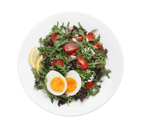 Photo of Delicious salad with boiled egg, arugula and tomatoes isolated on white, top view