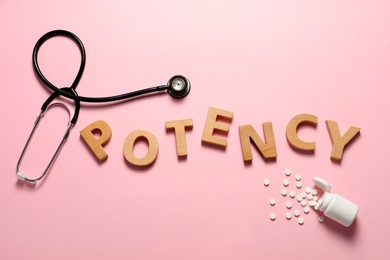 Photo of Word Potency made of wooden letters, stethoscope and pills on light pink background, flat lay