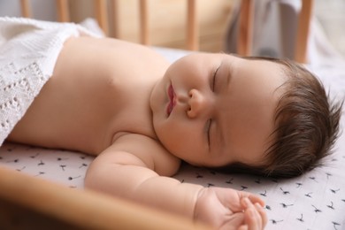 Cute little baby sleeping in crib at home. Bedtime