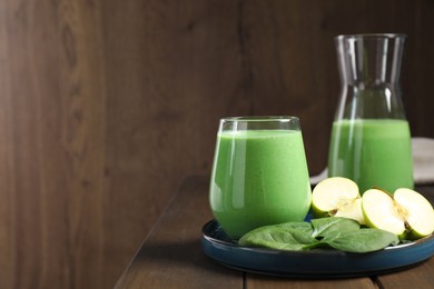 Tasty fresh spinach and apple smoothie on wooden table, space for text