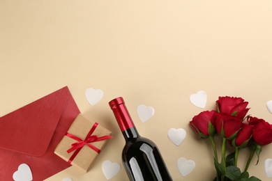 Flat lay composition with gift box and roses on beige background, space for text. Valentine's day celebration