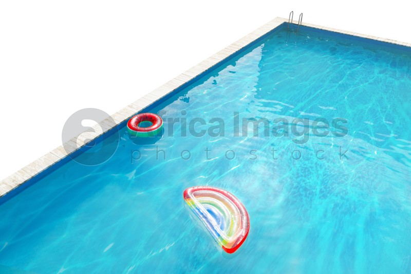 Modern swimming pool with inflatable mattress and ring isolated on white