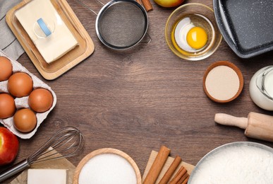 Photo of Flat lay composition with culinary utensils and ingredients on wooden table, space for text. yeast pastry