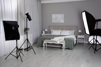 Professional photo studio equipment prepared for shooting bedroom interior