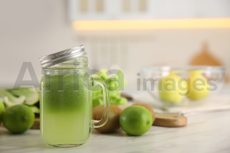 Tasty fresh juice in mason jar on table indoors. Space for text