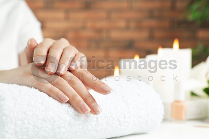 Woman showing smooth hands on towel at table, closeup with space for text. Spa treatment