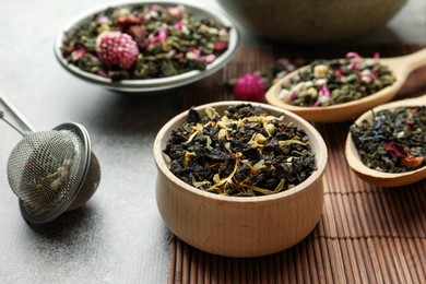 Different herbal teas on grey table, closeup