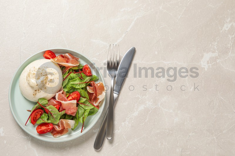 Delicious burrata salad served on light grey marble table, flat lay. Space for text