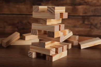 Jenga tower and wooden blocks on table