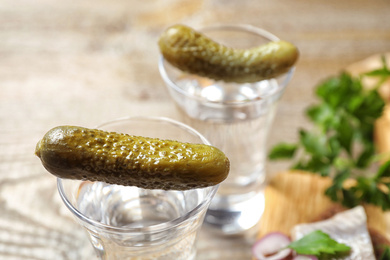 Cold Russian vodka with pickles on table, closeup