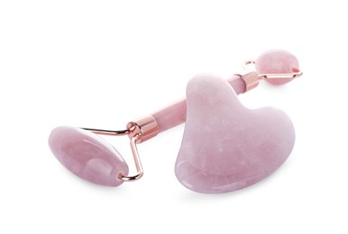 Photo of Rose quartz gua sha tool and facial roller isolated on white