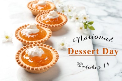 National Dessert Day, October 14. Tasty tartlets with jam on white marble table