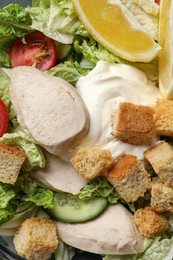 Delicious salad with Chinese cabbage, meat and bread croutons as background, top view
