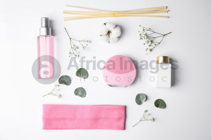 Photo of Composition with face cleansing brush on white background, top view. Cosmetic accessory