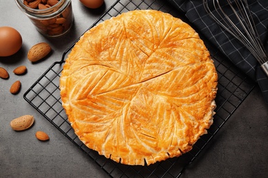 Traditional galette des rois and ingredients on grey table, flat lay