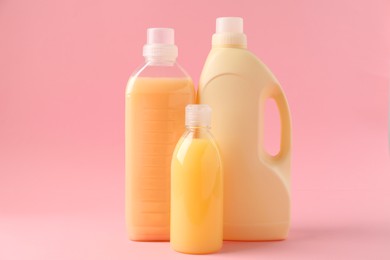 Bottles of laundry detergents on pink background