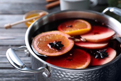 Delicious mulled wine on table, closeup view