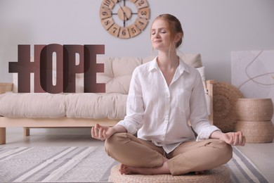 Concept of hope. Woman meditating on wicker mat at home