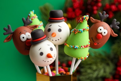 Delicious Christmas themed cake pops on blurred background, closeup