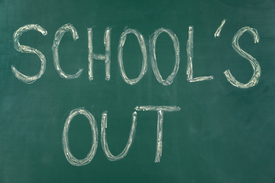 Text School's Out written on green chalkboard. Summer holidays
