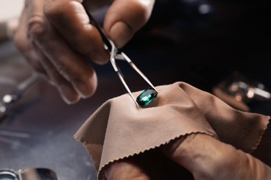 Photo of Professional jeweler working with gemstone, closeup view