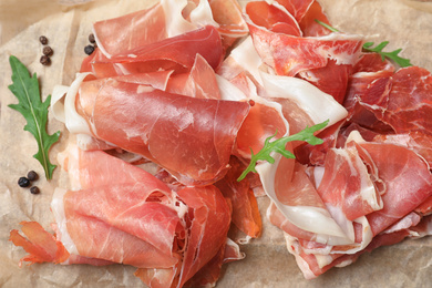 Pile of tasty prosciutto on parchment, closeup