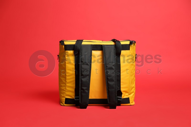 Modern yellow thermo bag on red background
