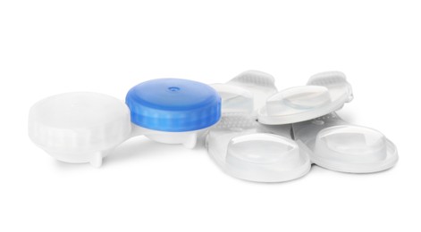 Photo of Packages with contact lenses and case on white background