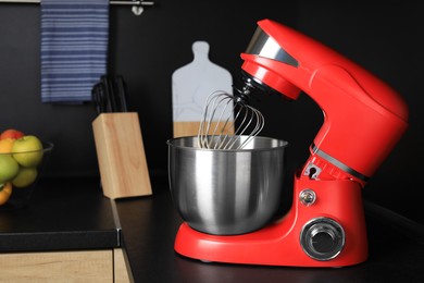 Photo of Modern stand mixer on countertop in kitchen. Home appliance