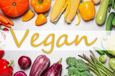 Word Vegan and fresh vegetables on white wooden background, flat lay