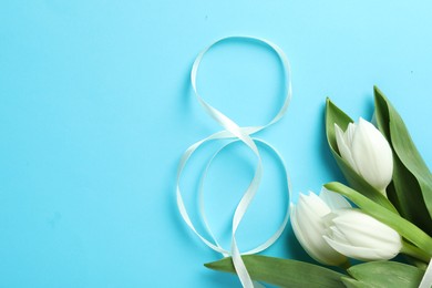 Photo of 8 March card design with tulips and space for text on light blue background, flat lay. International Women's Day