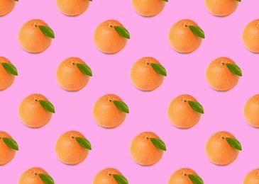 Many fresh ripe grapefruits on pink background. Seamless pattern design