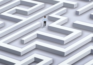 Image of Thoughtful businesswoman trying to find way out of maze