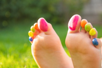 Photo of Teenage girl with painted toes outdoors, closeup