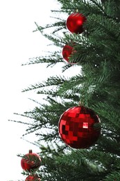 Beautiful Christmas tree with red baubles on white background, closeup