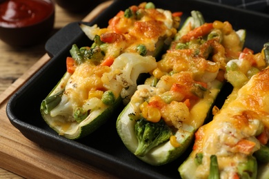 Baking dish with delicious stuffed zucchinis, closeup