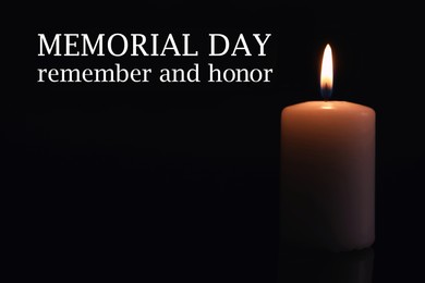 Image of Memorial day. Wax candle burning on black background