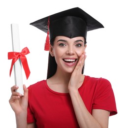 Emotional student with graduation hat and diploma on white background