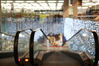 Photo of Blurred view of shopping mall interior decorated for Christmas. Bokeh effect