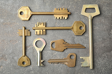 Steel keys on grey background, flat lay. Safety concept