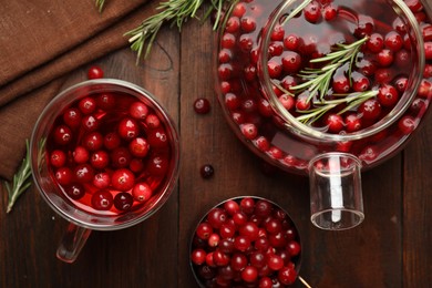 Photo of Tasty hot cranberry tea on wooden table, flat lay