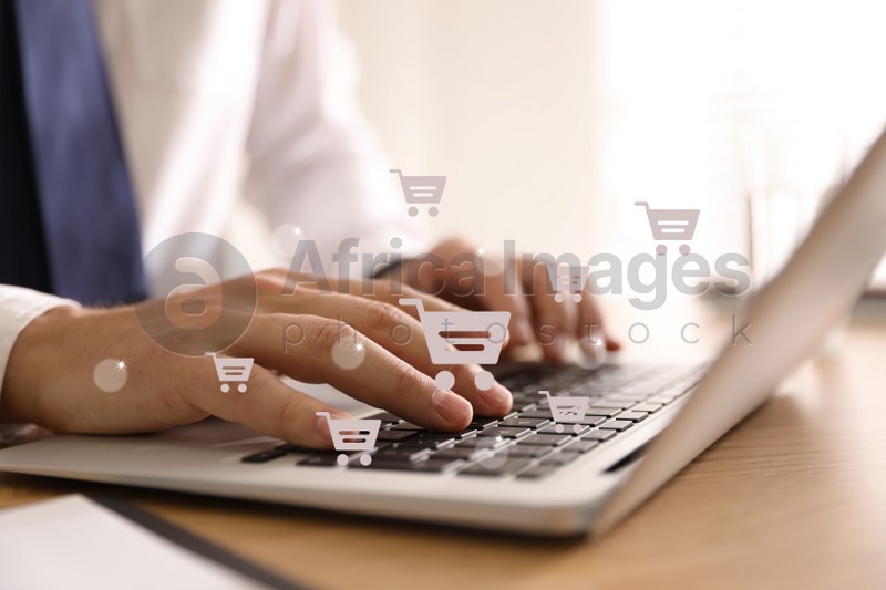 Delivery concept. Man using modern laptop for online shopping indoors, closeup. Market cart illustrations