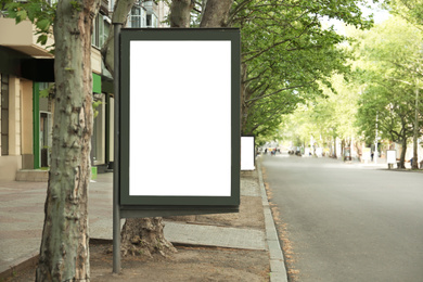Blank advertising board on city street. Space for design