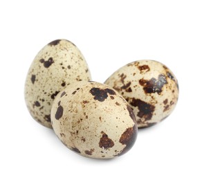 Three beautiful quail eggs on white background