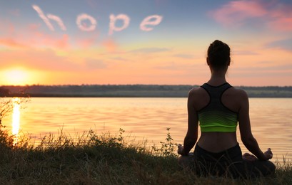 Concept of hope. Woman meditating at sunset, back view