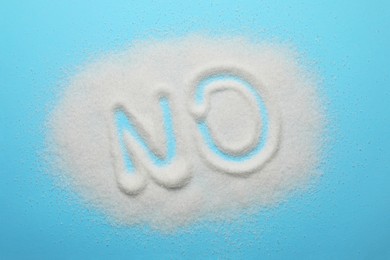 Word No made of sugar on light blue background, top view