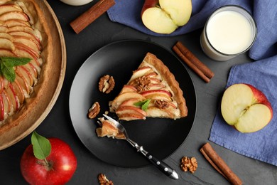 Delicious apple pie served on black table, flat lay