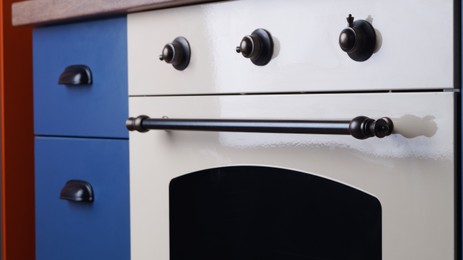 Photo of New stylish oven in kitchen, closeup. Cooking appliance