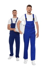 Photo of Professional plumbers with new heating radiator on white background